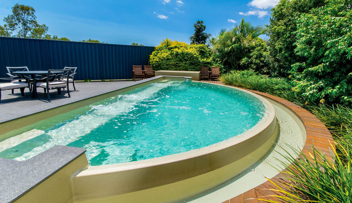 Leisure Pools Horizon fiberglass backyard patio swimming pool with an infinity edge