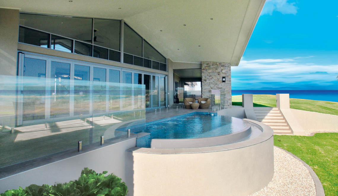 Leisure Pools Horizon composite fiberglass swimming pool with an infinity edge