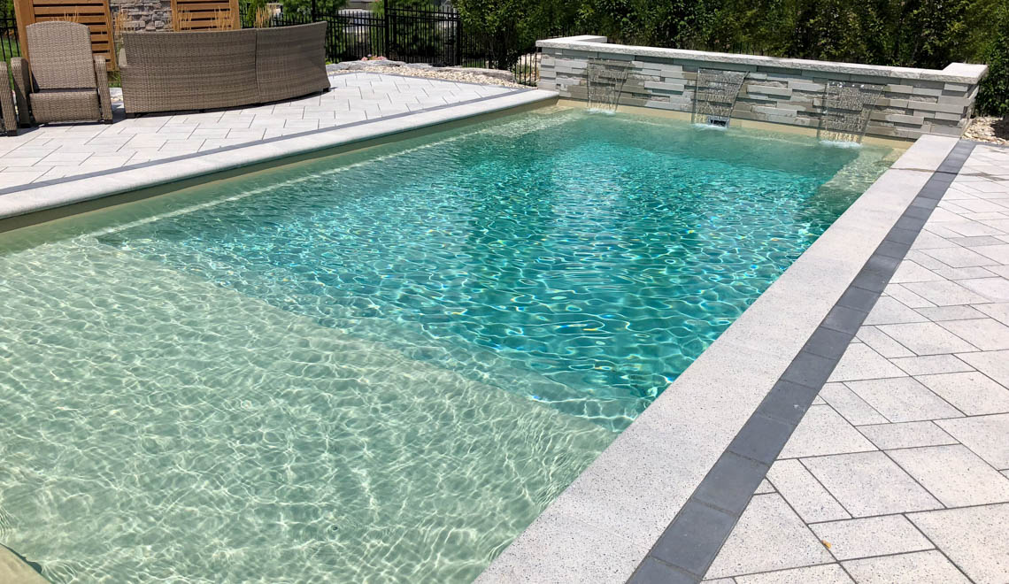 Leisure Pools Pinnacle large precast swimming pool with built-in splash deck
