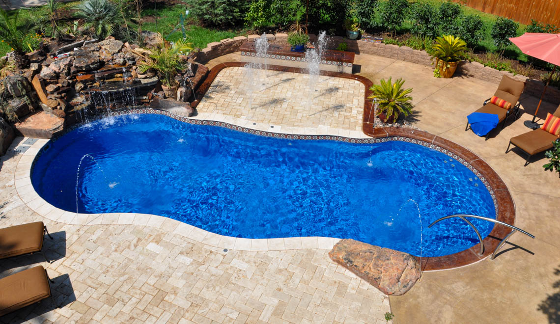 Leisure Pools Riviera large fiberglass freeform swimming pool with perimeter safety ledge