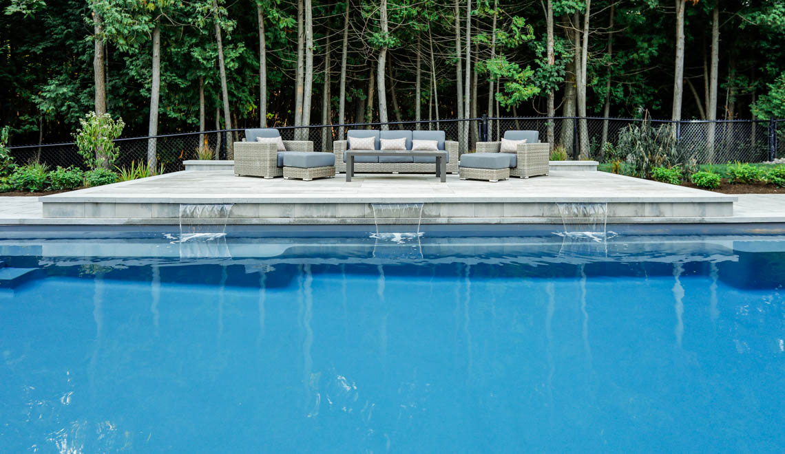 Leisure Pools Supreme composite fiberglass swimming pool with deep end swimout and bench seats