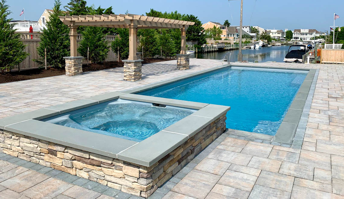 Leisure Pools Supreme composite in-ground swimming pool with perimeter safety ledge