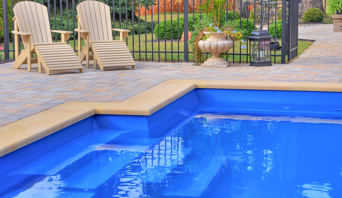 Leisure Pools Elegance fiberglass swimming pool with perimeter safety ledge