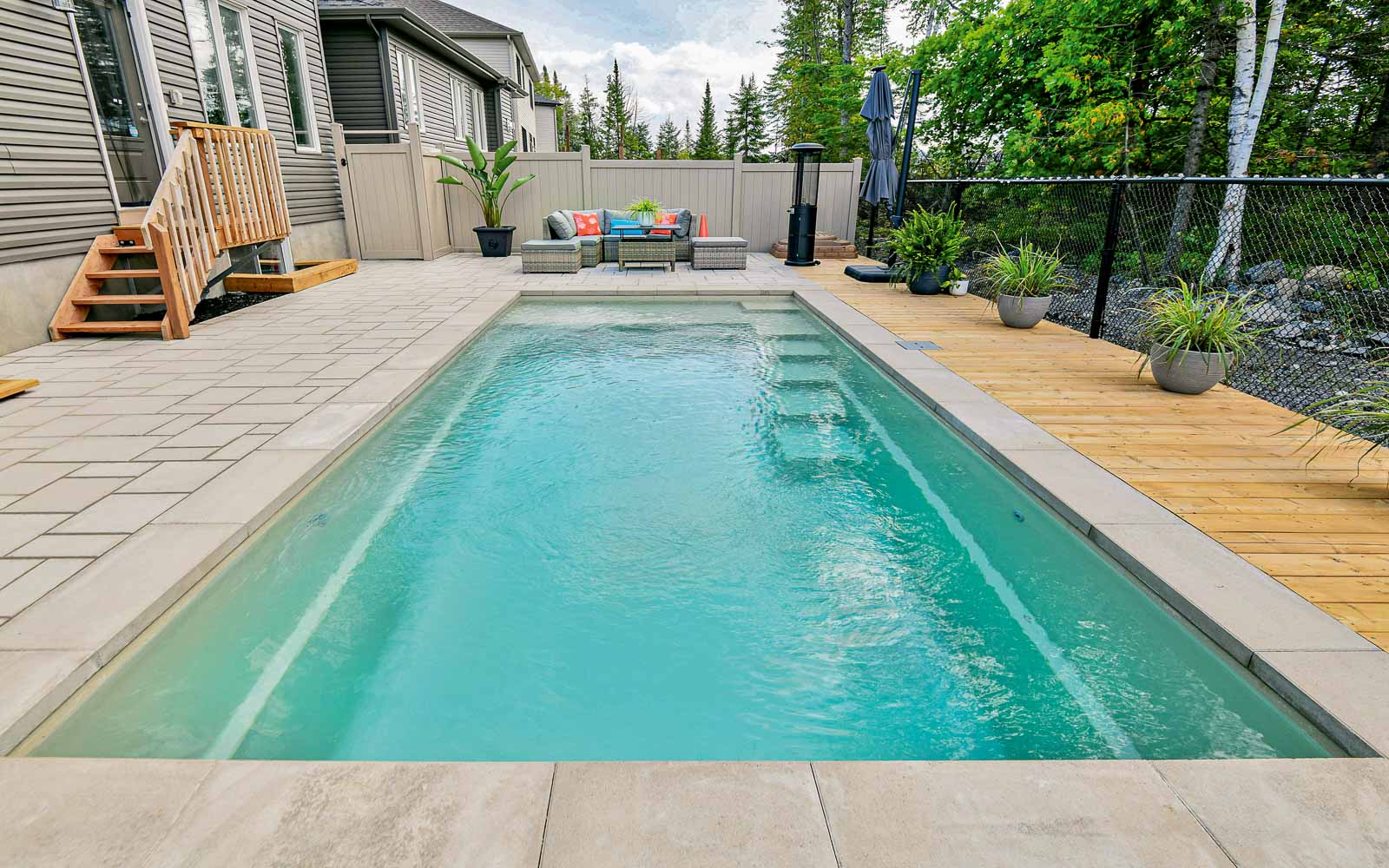 Leisure Pools Precision fiberglass swimming pool with built-in splash deck