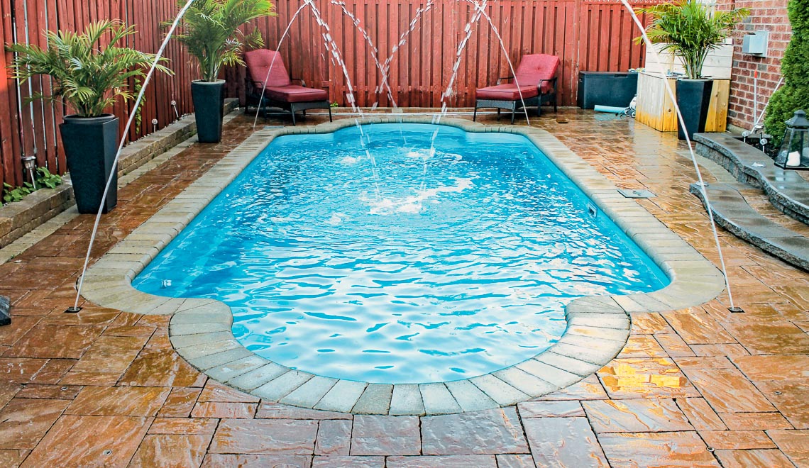 Leisure Pools Roman composite fiberglass swimming pool with spa nook and swimout