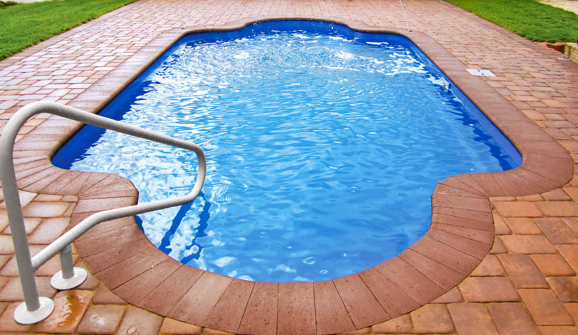 Leisure Pools Roman large fiberglass swimming pool with perimeter safety ledge