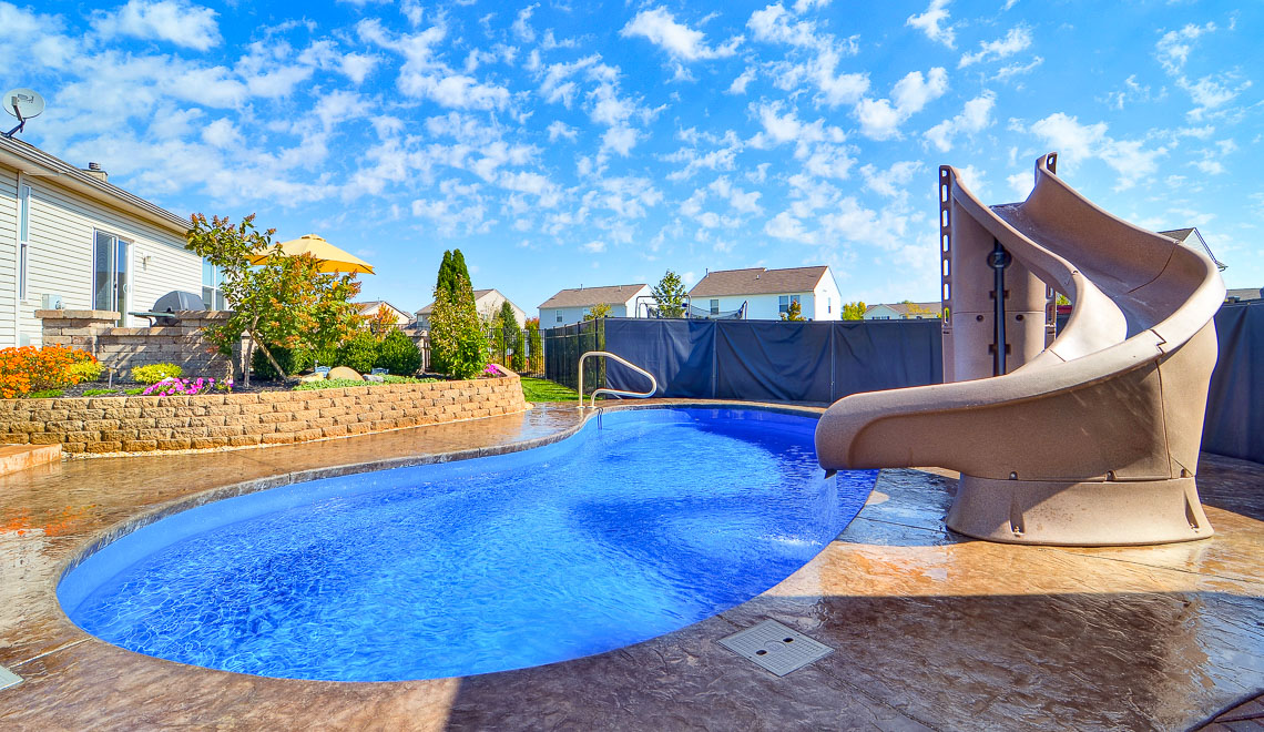 Leisure Pools Tuscany freeform composite fiberglass swimming pool with perimeter safety ledge