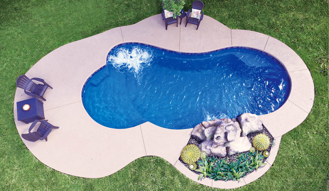 Leisure Pools Eclipse freeform fiberglass swimming pool with built-in splash deck