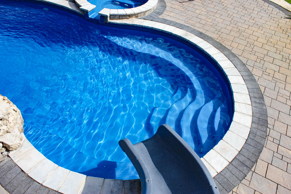 Leisure Pools Mediterranean composite freeform diving pool with wrap-around bench