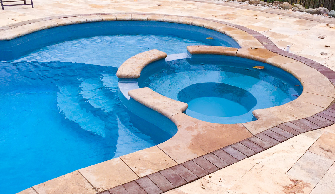 Leisure Pools Allure large freeform swimming pool with built-in spa and splash deck