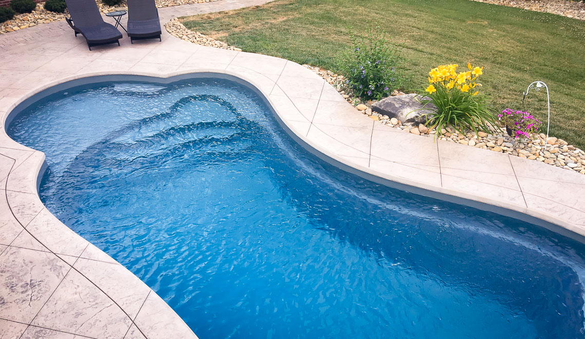 Leisure Pools Eclipse freeform in-ground swimming pool with built-in splash deck