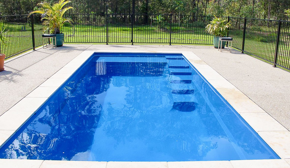 Leisure Pools Precision fiberglass flat bottom swimming pool with built-in splash deck