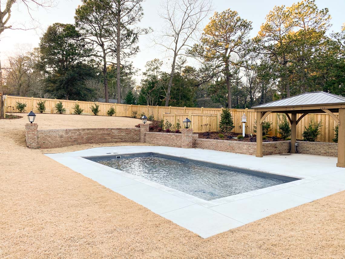 Leisure Pools Summit in-ground composite fiberglass swimming pool with integrated splash deck