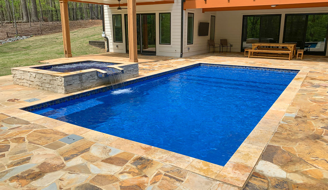 Leisure Pools Summit large composite fiberglass swimming pool with integrated splash deck
