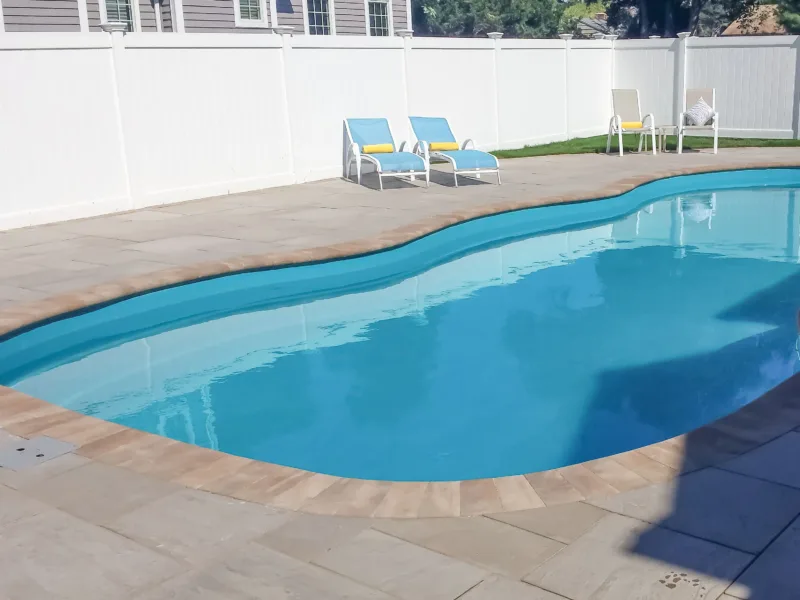 Fence providing privacy for inground fiberglass swimming pool